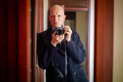 Self-portrait of Jean-Charles Boisset holding a camera, in a mirror